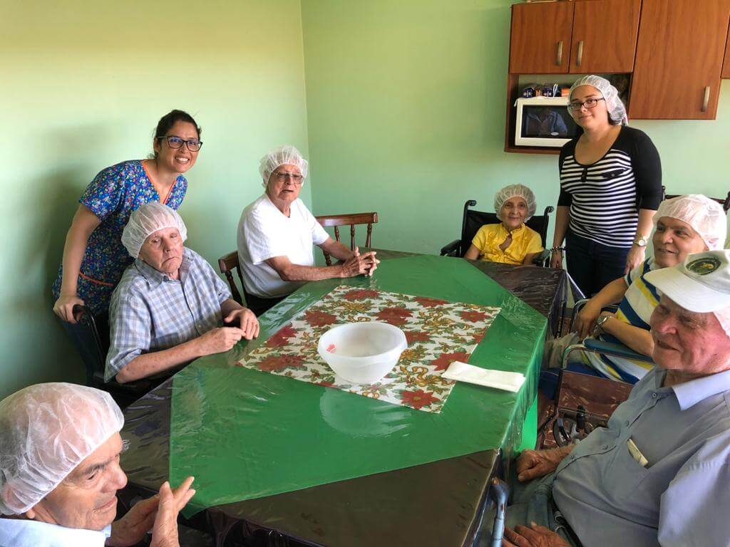 SeniorInnen sitzen um einen Tisch