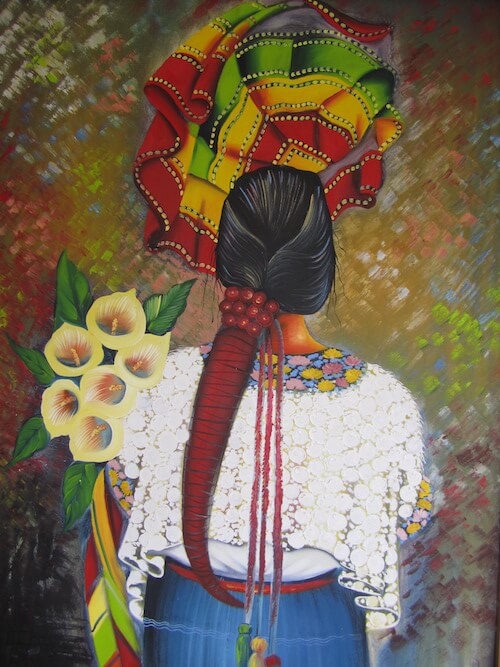 Ein Wandbild zeigt eine Frau von hinten mit einem langen Zopf, sie hält Sonnenblumen im Arm